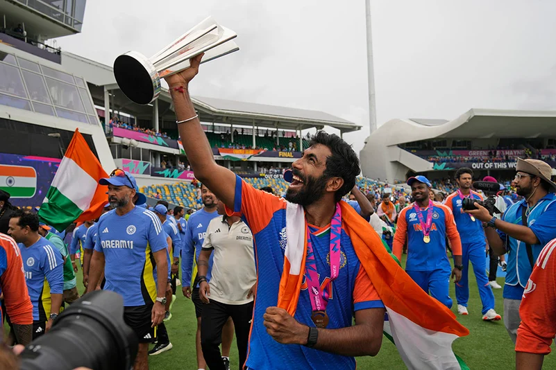 Jasprit Bumrah celebrates with the winners trophy